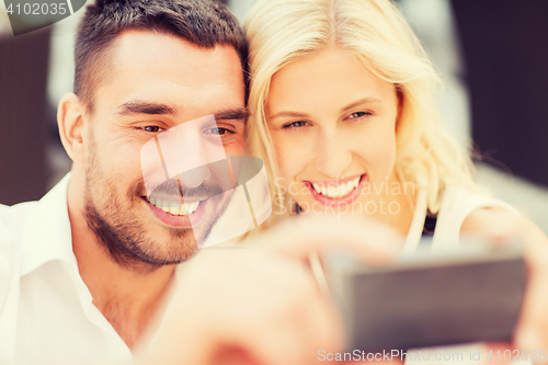 Image of happy couple taking selfie with smartphone 