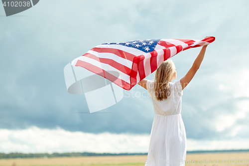 Image of happy woman with american flag on cereal field