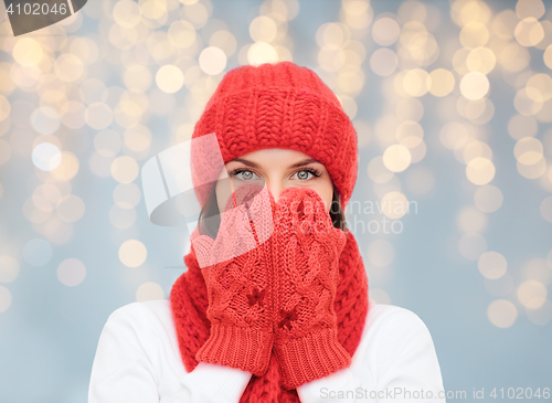 Image of surprised woman in hat, scarf and mittens