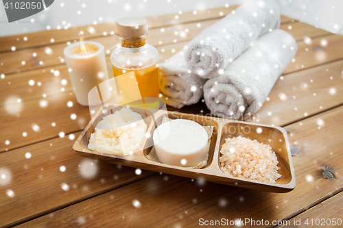 Image of soap, himalayan salt, scrub in bowl, towel and oil