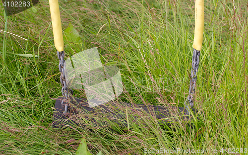 Image of Empty swing in playground 