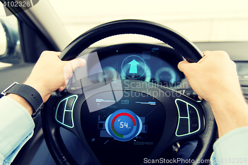 Image of close up of man driving car with volume level icon