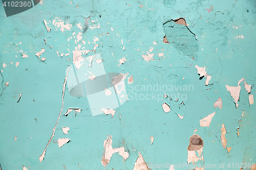 Image of blue or turquoise wall with peeling paint surface