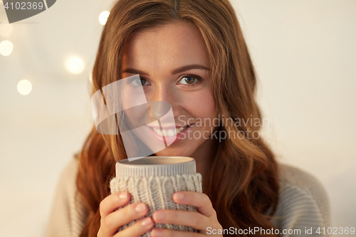 Image of close up of woman with tea or coffee cup at home