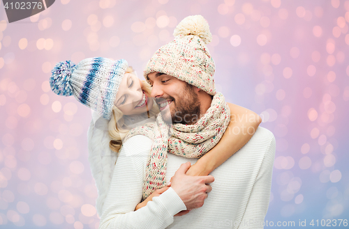 Image of smiling couple in winter clothes hugging