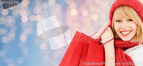 Image of smiling young woman with shopping bags