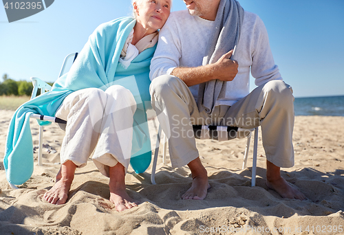 Image of close up of senior couple sitting on beach chairs