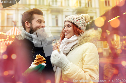 Image of happy couple walking in old town