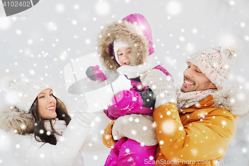 Image of happy family with child in winter clothes outdoors