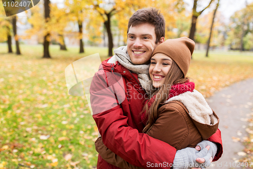 Image of happy young couple hugging in autumn park