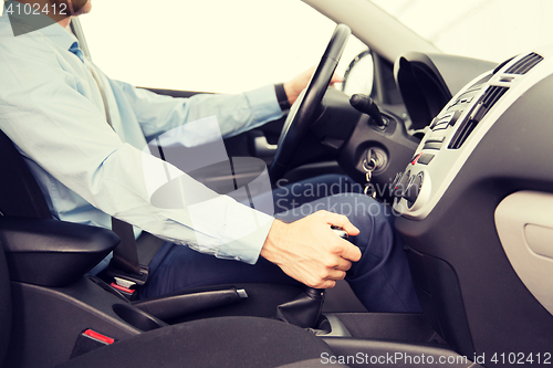 Image of close up of young man driving car