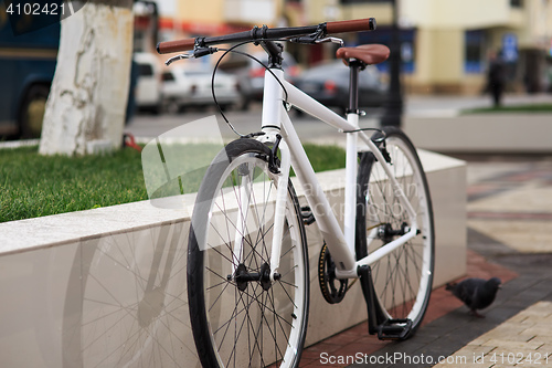 Image of white fixed-gear bicycle on street