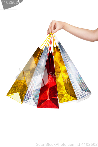 Image of Womans hand holding colorful shopping bags 