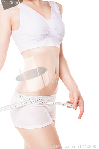 Image of Slimming woman measuring hip with tape