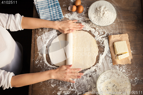 Image of Female cooking dough.