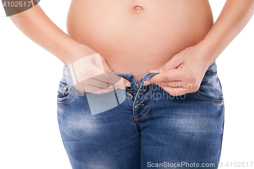 Image of Pregnant belly woman wearing jeans