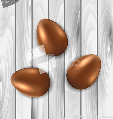 Image of Easter chocolate three eggs on grey wooden background