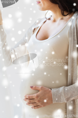 Image of close up of happy pregnant woman with big belly