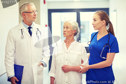 Image of medics and senior patient woman at hospital