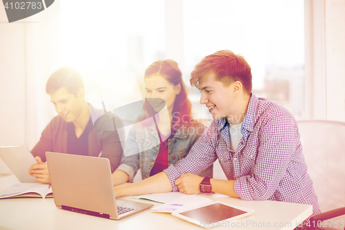 Image of students with laptop, notebooks and tablet pc