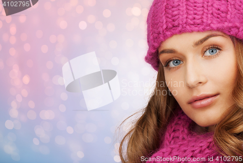 Image of close up of woman in hat and scarf over lights