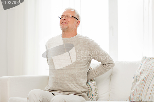 Image of unhappy senior man suffering from backache at home
