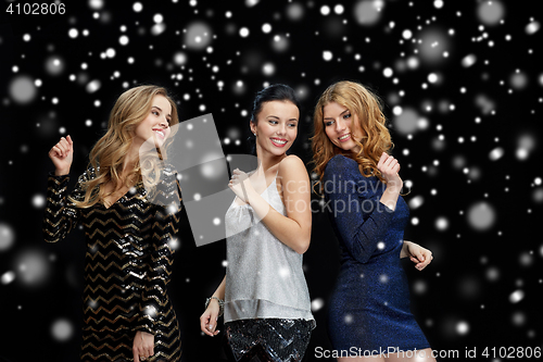 Image of happy young women dancing at night club disco