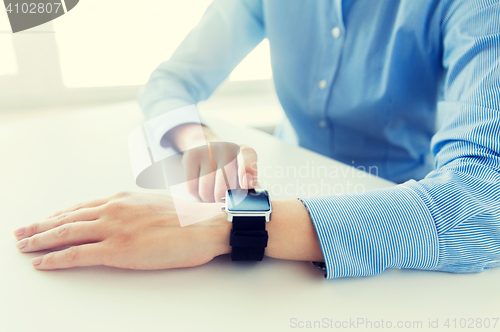 Image of close up of hands setting smart watch