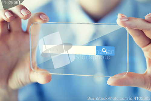 Image of close up of woman with transparent smartphone