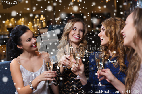 Image of happy women with champagne glasses at night club