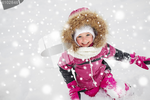 Image of f happy little child or girl with snow in winter
