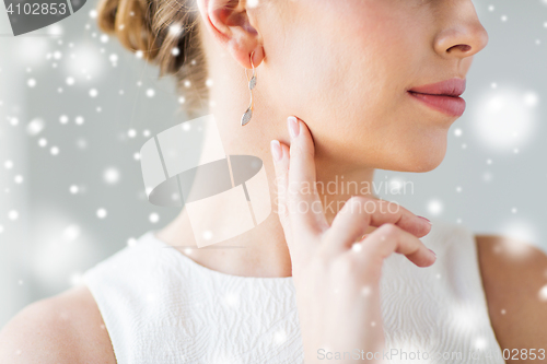 Image of close up of beautiful woman face with gold earring