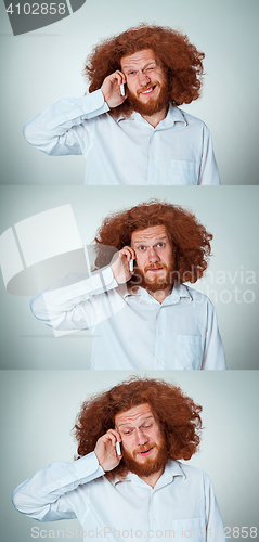 Image of Portrait of puzzled man talking on the phone  a gray background