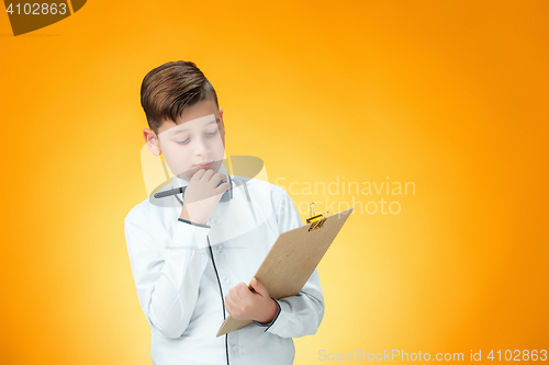 Image of The boy with pen and tablet for notes