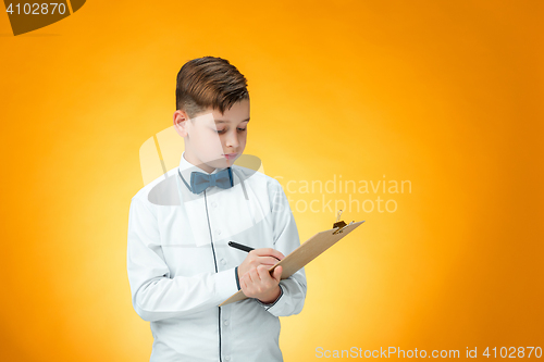 Image of The boy with pen and tablet for notes