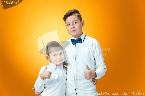 Image of Happy children showing thumbs up sign OK