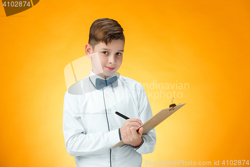 Image of The boy with pen and tablet for notes