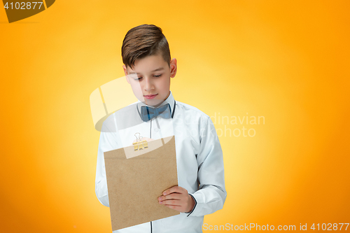 Image of The boy with pen and tablet for notes