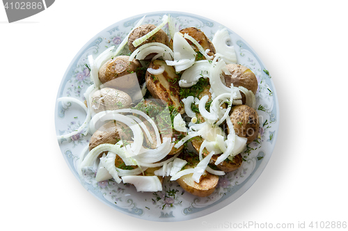 Image of baked potatoes with the peel, onion and fennel, drizzled oil on a plate gray ornament. Isolation, cliping mask