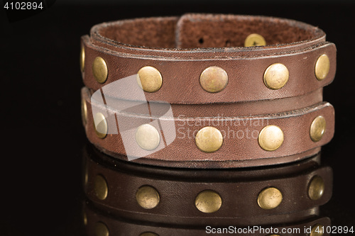 Image of Brown leather bracelet isolated on a black