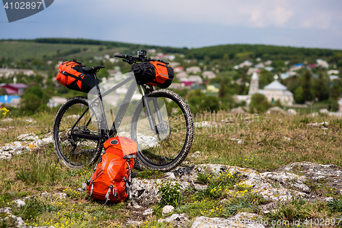 Image of Bicycle with orange bags for travel