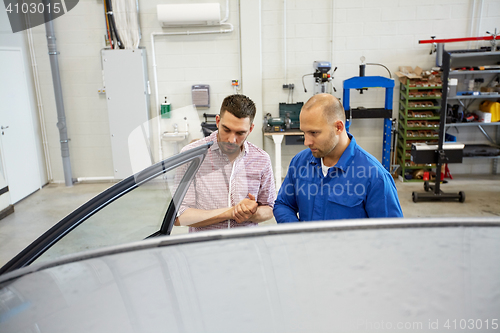 Image of auto mechanic and man at car shop