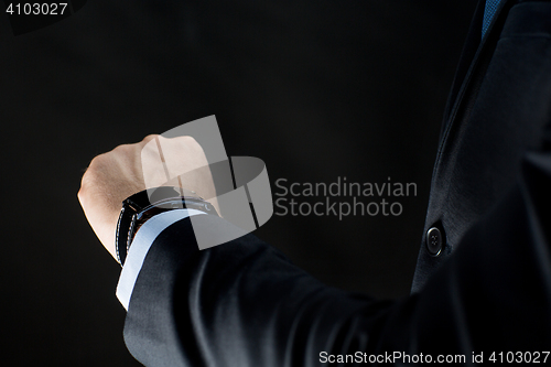 Image of close up of businessman hand with smart watch