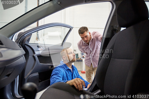 Image of auto mechanic and man at car shop