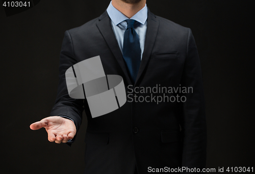Image of close up of businessman holding something on hand