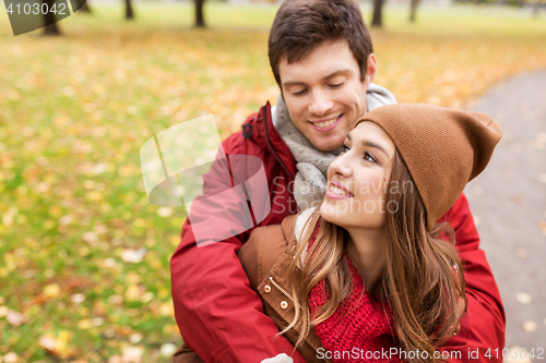 Image of happy young couple hugging in autumn park