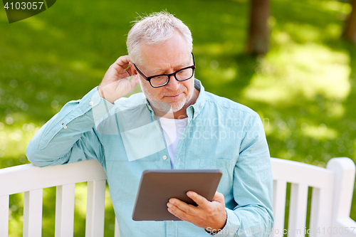 Image of senior man with tablet pc at summer park