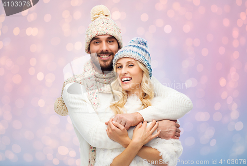 Image of smiling couple in winter clothes hugging