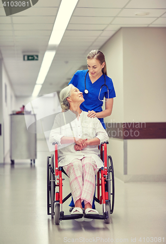 Image of nurse with senior woman in wheelchair at hospital