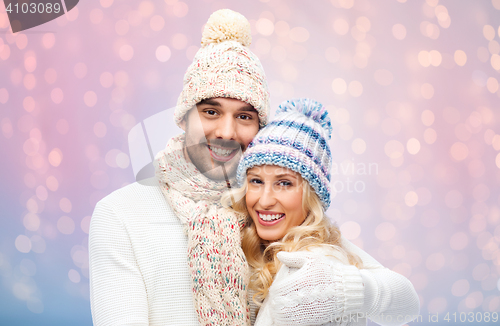 Image of smiling couple in winter clothes hugging